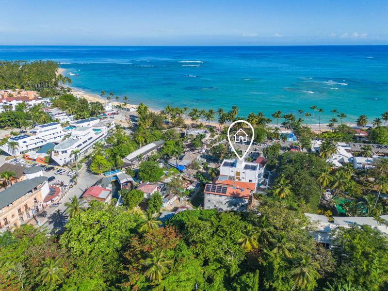 Las Terrenas from above — the house marked among palms, steps from the water